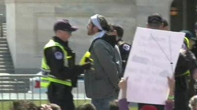 A protester being led away by police