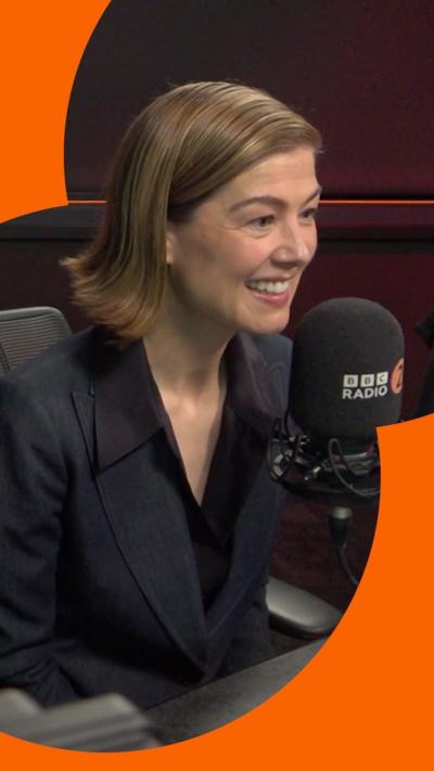 A woman, Rosamund Pike, wearing a blazer.