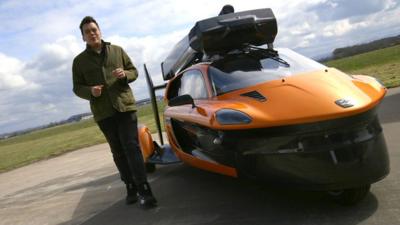 Nick Kwek (L) stands next to a decommissioned PAL-V (a personal air and land vehicle)