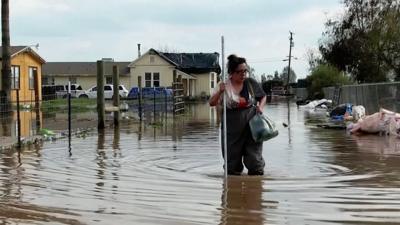 Woman in flood water