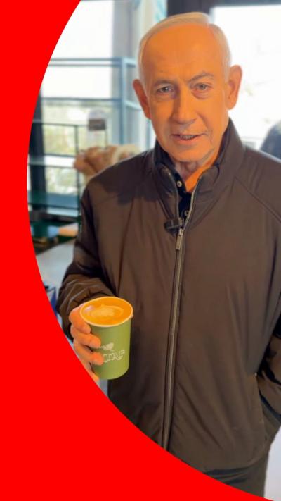 Israeli Prime Minister Benjamin Netanyahu holding a cup of coffee