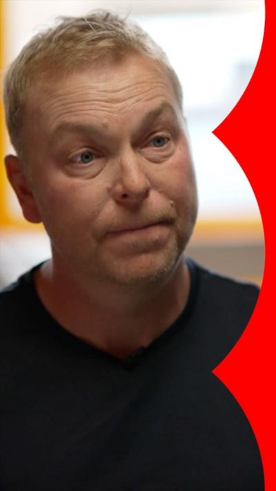 A blonde man, Sir Chris Hoy, in a black t shirt.