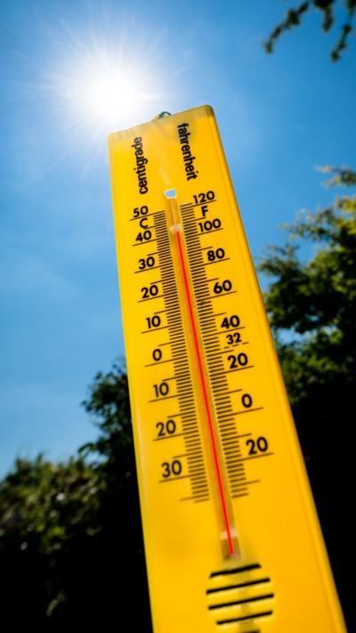 Thermometer against a sunny sky
