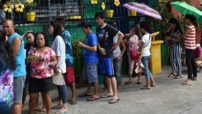 Voters queue to cast their ballots in Manila