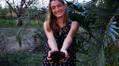 Sasha holding fertiliser made from human waste