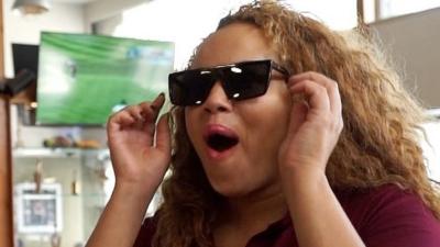 Woman wearing sunglasses with surprised expression