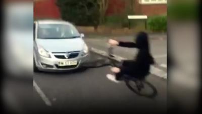 Teenage boy on bike about to crash with car