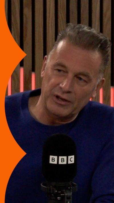 Chris Packham wearing a blue jumper in a BBC studio.