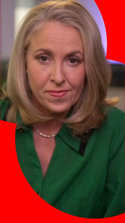 Sarah Smith has shoulder-length blonde hair and is wearing a green jacket. She looks directly at the camera.