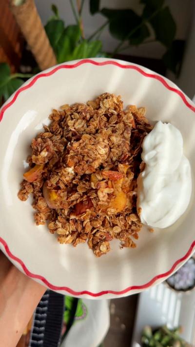 Peach breakfast crumble on a white plate from above