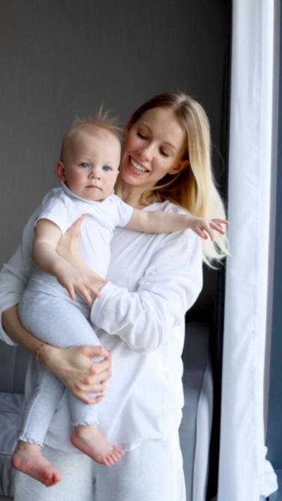 A woman smiles at her baby
