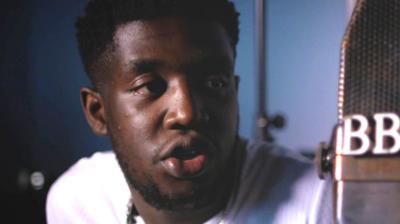 Femi Koleoso talks into a BBC radio microphone