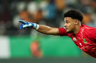 Ronwen Williams in red goalkeeper jersey points as he leans forward