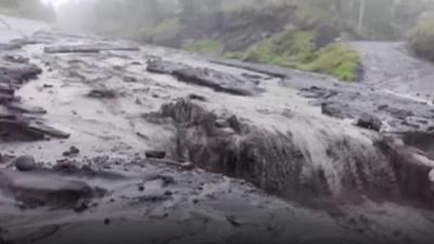 Mud flowing down a broken road