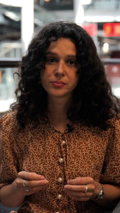 Close-up of woman in brown top
