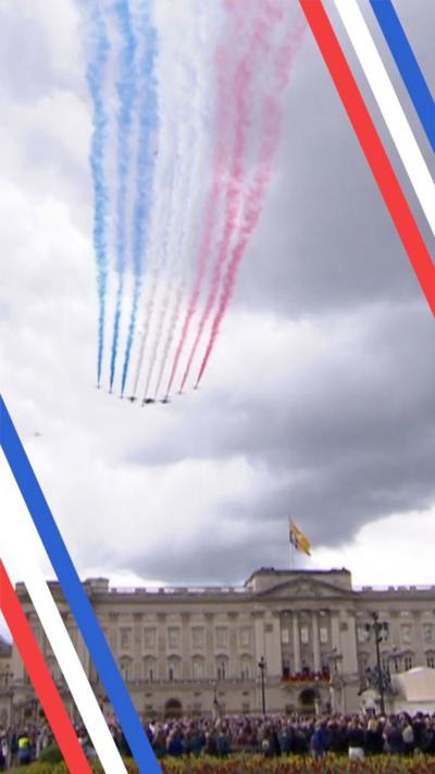 Red Arrows stream smoke as they fly over Buckingham Palace