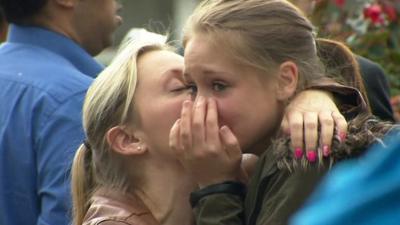 A young woman is comforted