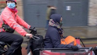 Woman on a courier bike