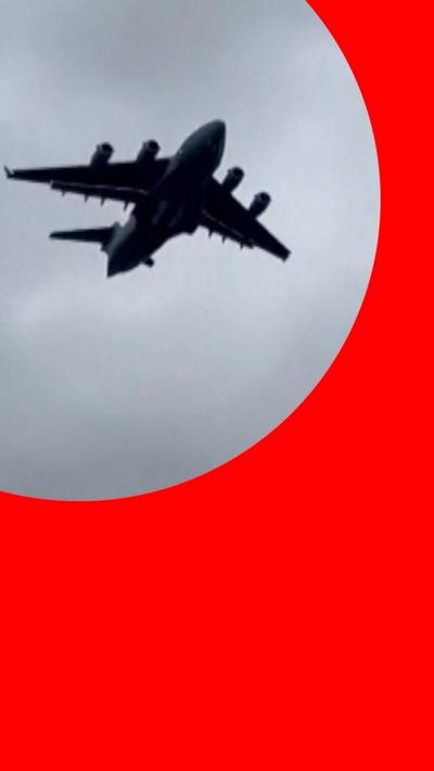 Screengrab of a video showing a plane flying at low altitude over a building in Moscow
