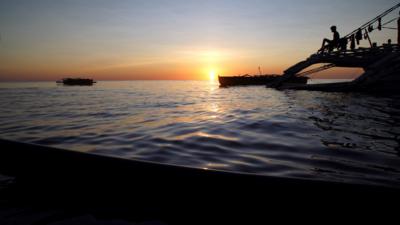 Sunset over Philippine fishing boat in South China Sea