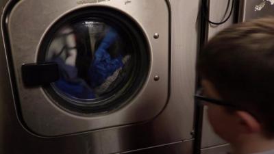 Boy looks at washing machine