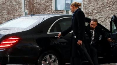 Prime Minister Theresa May gets stuck in car door