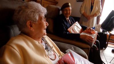 Older woman and older man in chairs