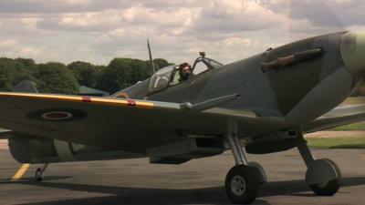 Pilot in the cockpit of a Spitfire as preparations take place for an RAF flypast marking the Battle of Britain's 'hardest day'