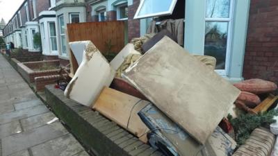 Furniture outside a house damaged by storms in Warwick Road, Carlisle