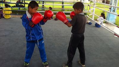 Two young boys practice boxing at a Manipur training camp