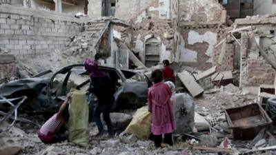 Family surrounded by rubble