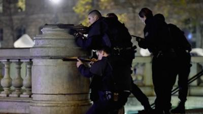 Armed police are deployed and take aim in Place de la Republique during a false alarm incident on November 15, 2015