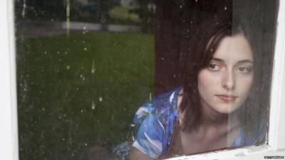 Young woman look out the window in the countryside