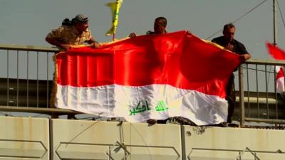 Flag of Iraq is unfurled in Falluja