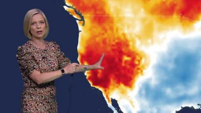 Weather presenter Sarah Keith-Lucas standing in front of a heat map of the western USA