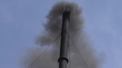 Incinerator chimney billows smoke