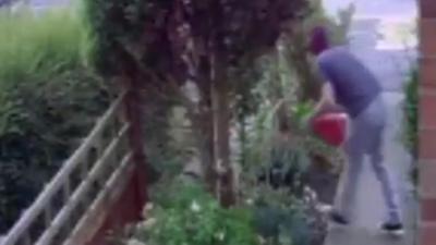 Early-morning CCTV pictures show him picking up the garden ornament before taking a tumble.