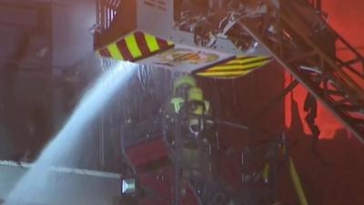 Person approaching cherry picker from balcony