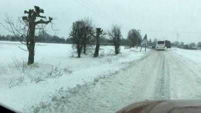 Suffolk Police urged drivers to avoid the road after vehicles became stranded.