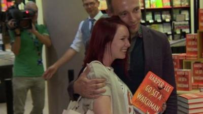 Couple posing with copy of book