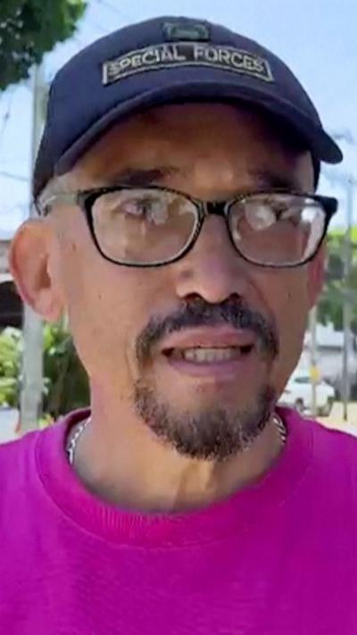 A man is talking to a reporter after the earthquake.