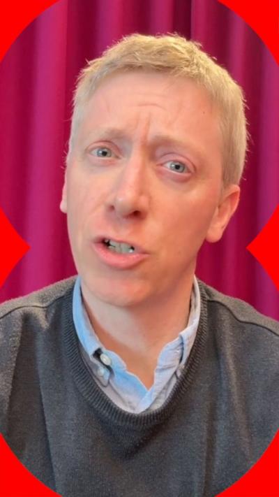 The BBC's Kevin Peachy wearing a grey jumper and blue shirt and appearing to be mid sentence