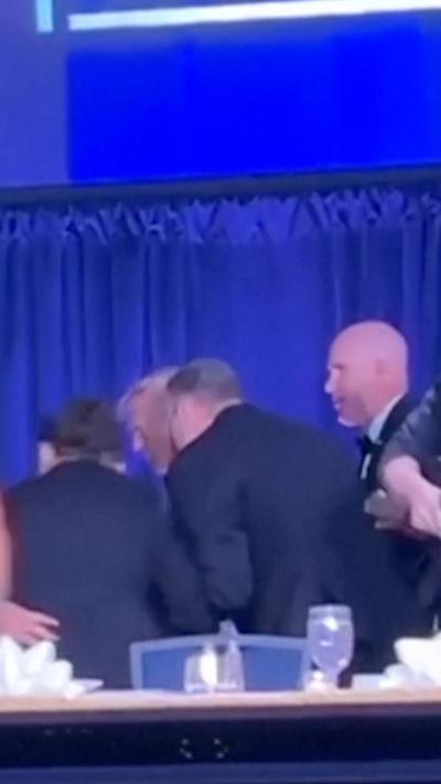 Security escorts Trump away from table