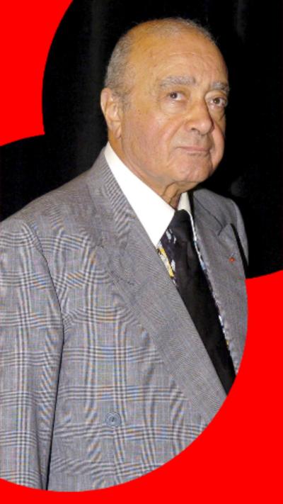 a man looks at the camera - he is wearing a gray suit, white shirt and a black tie