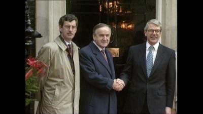 John Major and Albert Reynolds shake hands on the steps of 10 Downing Street.