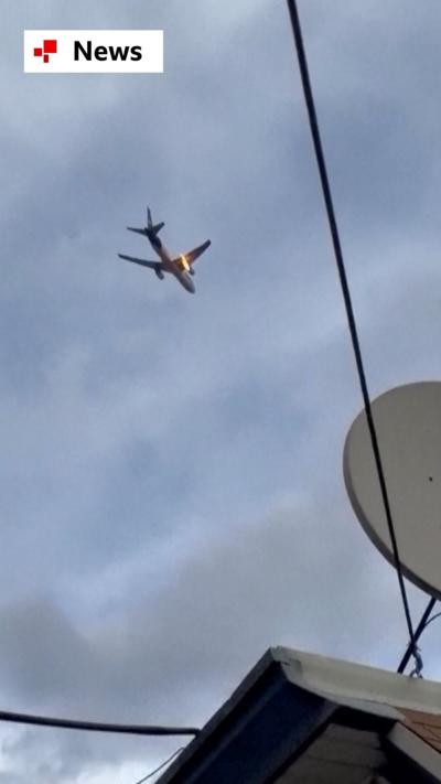 Video captured from the ground shows a FedEx cargo plane returning to Newark Airport to make an emergency landing.