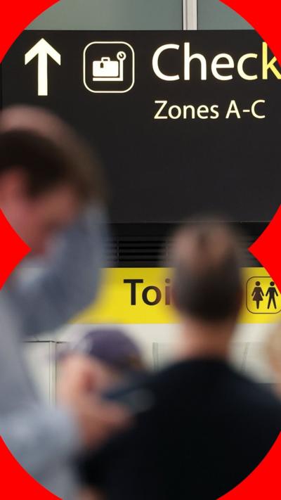 A sign showing the way to a check-in desk at Gatwick Airport