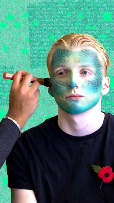 Rahual paints some creative make-up on a model's face