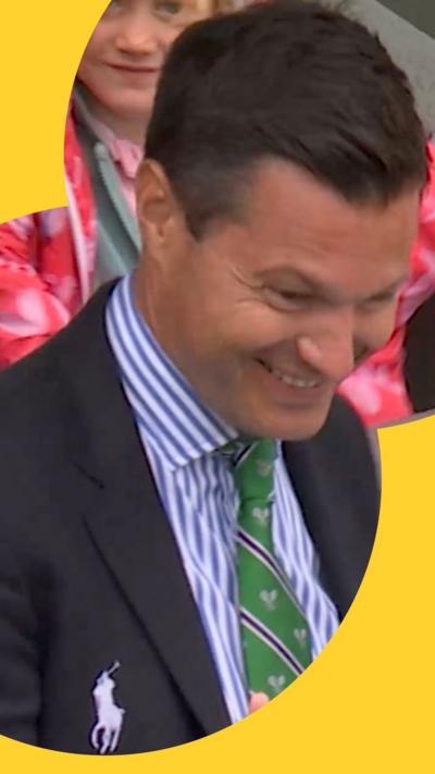 Umpire wearing suit laughs with his head aimed down