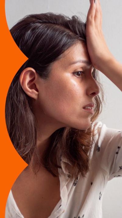 A woman looking to the right with her hand on her forehead, exasperated.